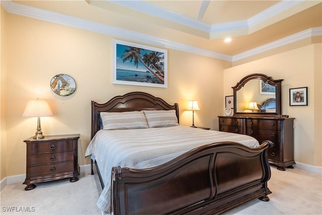 bedroom featuring light carpet, a tray ceiling, ceiling fan, and crown molding