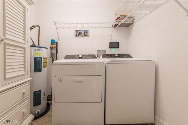 washroom with washer and dryer and water heater