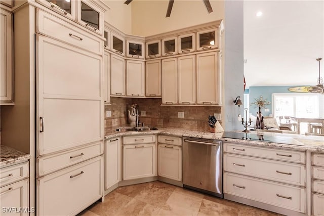 kitchen featuring stainless steel dishwasher, sink, cream cabinets, and backsplash