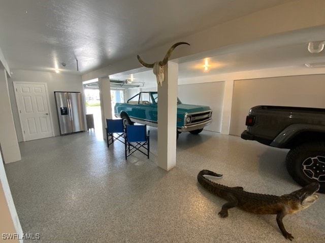 garage featuring stainless steel fridge