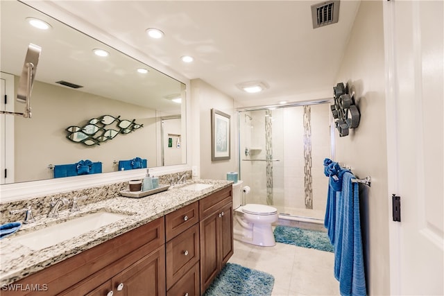 bathroom featuring tile patterned flooring, vanity, toilet, and an enclosed shower