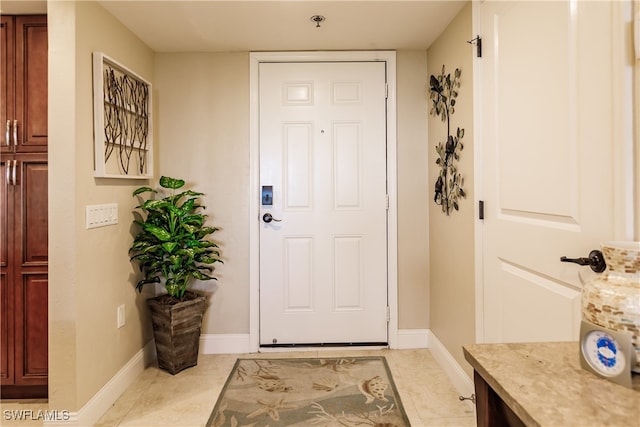 doorway with light tile patterned floors