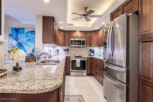 kitchen featuring backsplash, sink, light tile patterned floors, appliances with stainless steel finishes, and light stone counters