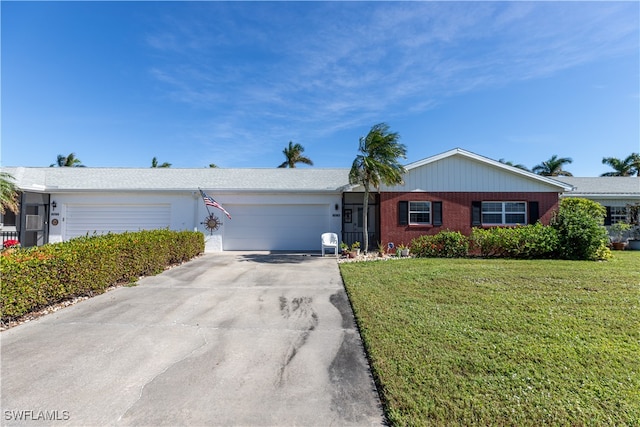 ranch-style house featuring a garage and a front lawn