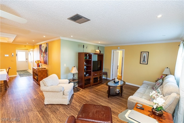 living room featuring hardwood / wood-style flooring, crown molding, and a textured ceiling