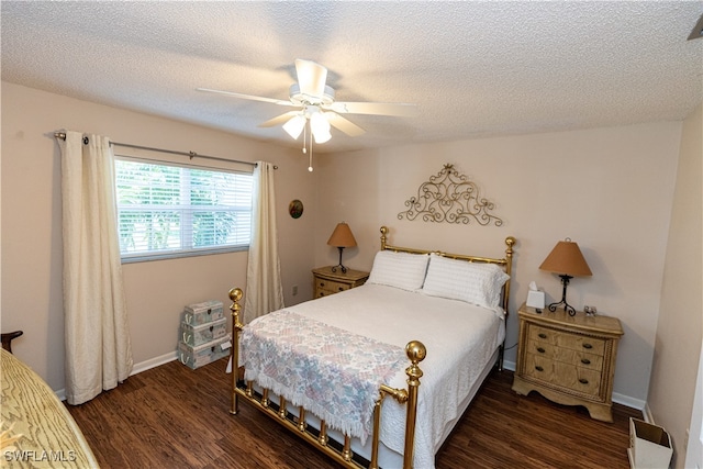 bedroom featuring ceiling fan, dark hardwood / wood-style floors, and a textured ceiling