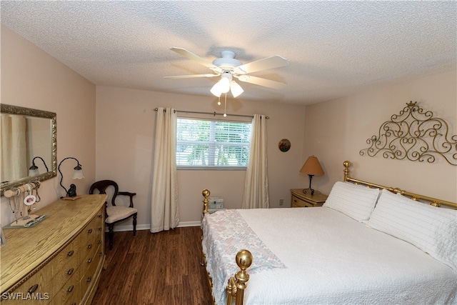 bedroom featuring ceiling fan, dark hardwood / wood-style floors, and a textured ceiling