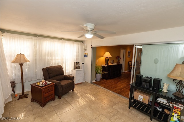 sitting room with ceiling fan and light hardwood / wood-style flooring