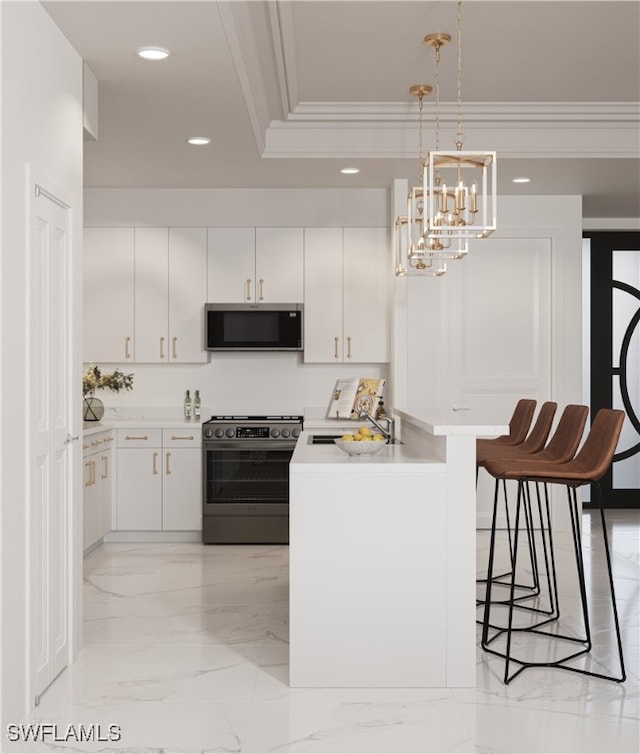 kitchen with a breakfast bar, black range oven, sink, hanging light fixtures, and white cabinetry