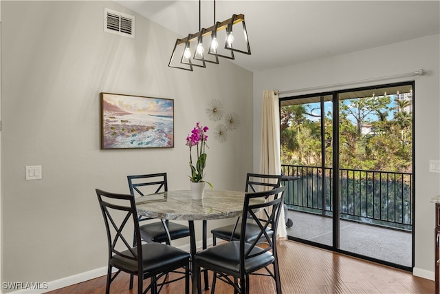 dining area with wood-type flooring