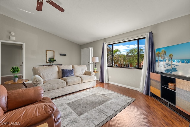 living room featuring hardwood / wood-style floors, ceiling fan, and vaulted ceiling