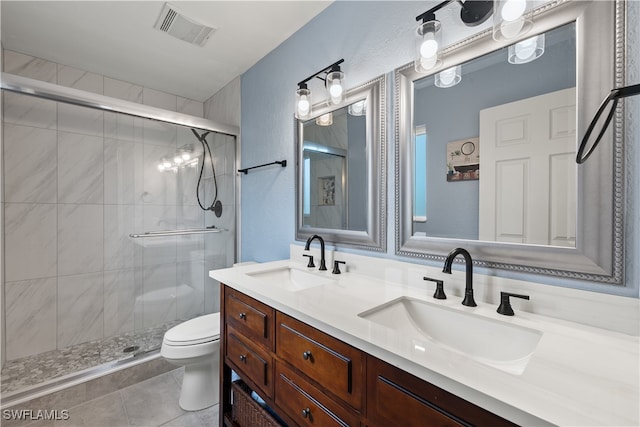 bathroom featuring tile patterned floors, vanity, an enclosed shower, and toilet