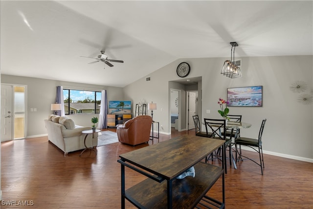 dining room with dark hardwood / wood-style flooring, vaulted ceiling, and ceiling fan