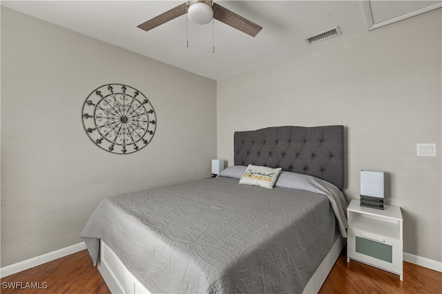 bedroom with dark hardwood / wood-style flooring and ceiling fan