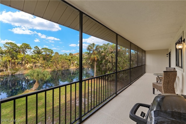 unfurnished sunroom featuring a water view