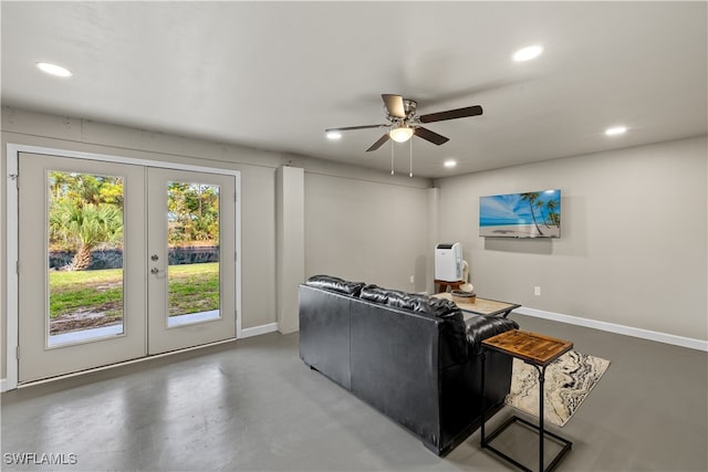 living room featuring ceiling fan, french doors, and concrete flooring