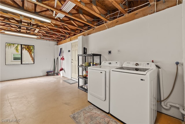 clothes washing area with separate washer and dryer