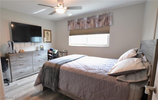 bedroom with light hardwood / wood-style floors and ceiling fan