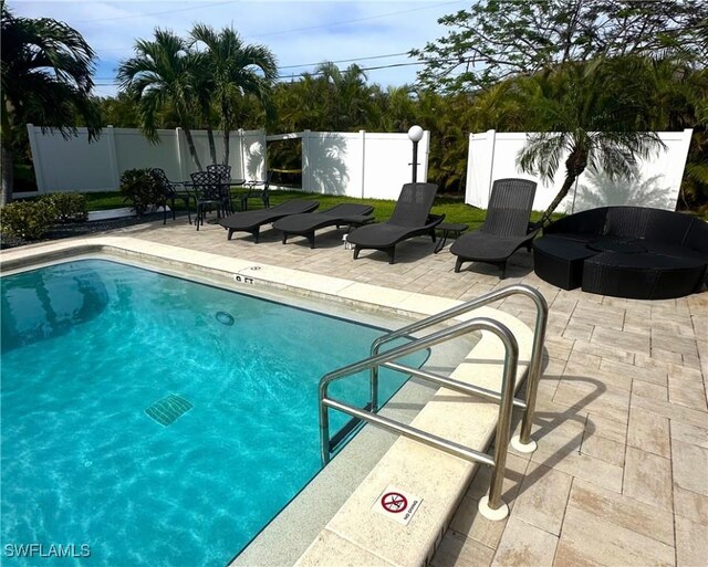 view of swimming pool featuring a patio area