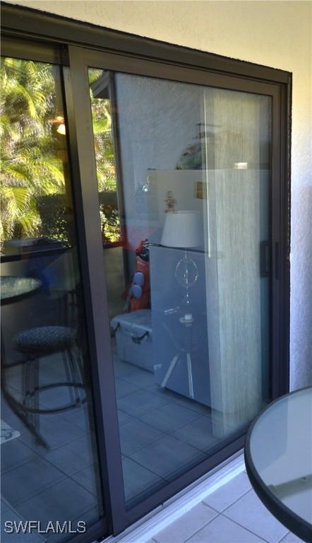 doorway to outside featuring tile patterned flooring