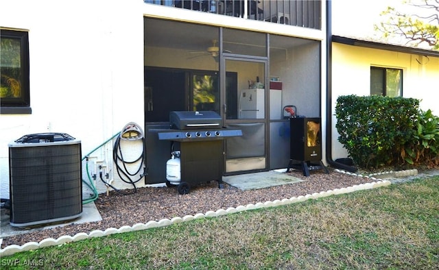 view of patio with central AC unit, a sunroom, and a grill