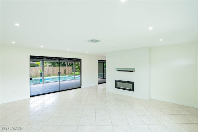 unfurnished living room featuring light tile patterned floors