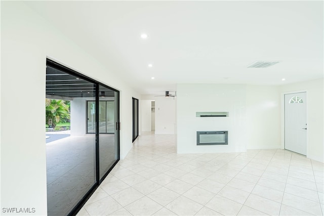 unfurnished living room with ceiling fan