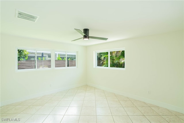 spare room featuring ceiling fan and light tile patterned flooring