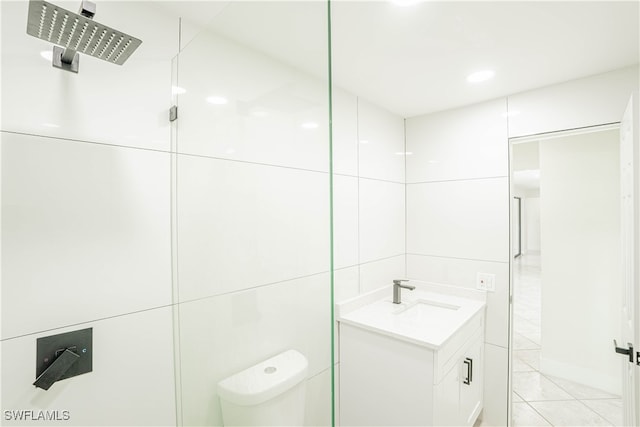 bathroom with tile patterned flooring, vanity, toilet, and a shower