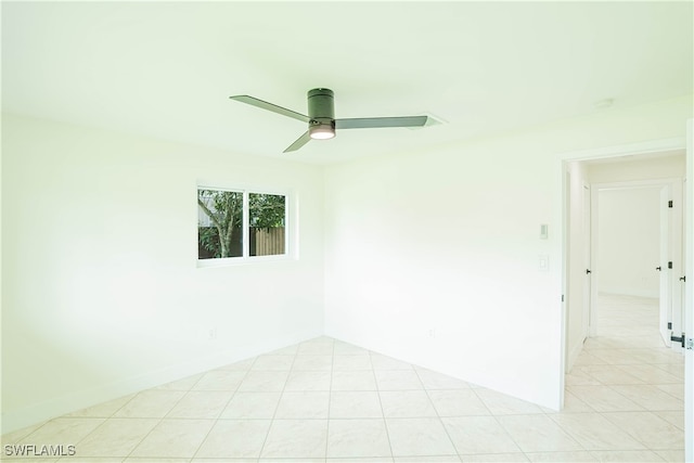 tiled empty room featuring ceiling fan