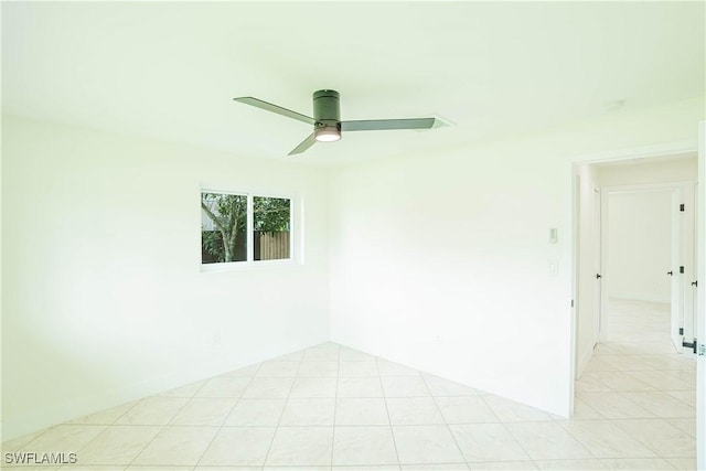 spare room with a ceiling fan and light tile patterned flooring