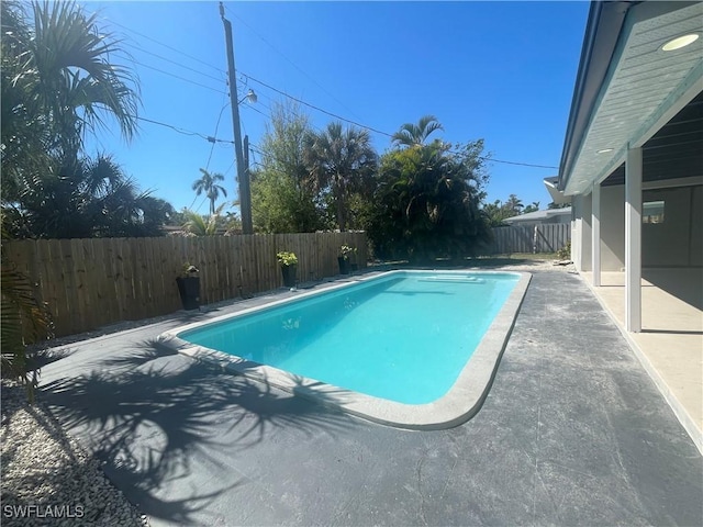 view of pool featuring a fenced in pool, a fenced backyard, and a patio