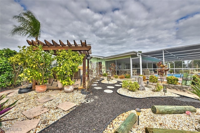 view of yard with a pergola, a pool, and a lanai