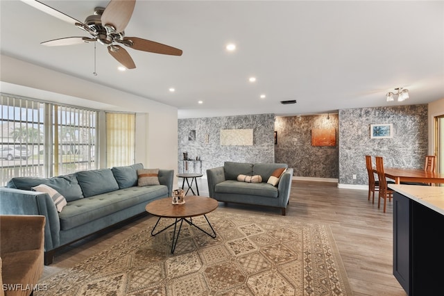 living room featuring hardwood / wood-style floors and ceiling fan