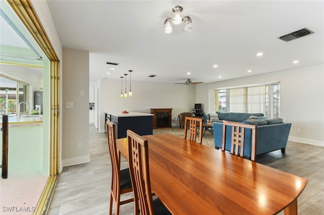 dining room with hardwood / wood-style flooring and ceiling fan