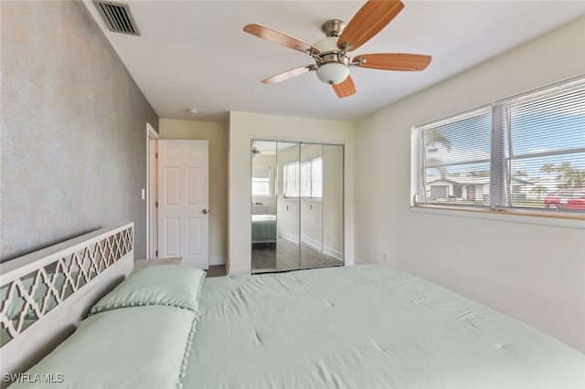 bedroom with hardwood / wood-style flooring, ceiling fan, and a closet