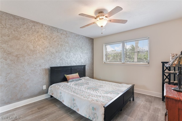 bedroom with ceiling fan and hardwood / wood-style floors