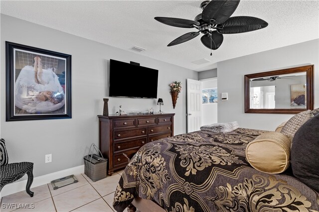 tiled bedroom featuring a textured ceiling and ceiling fan