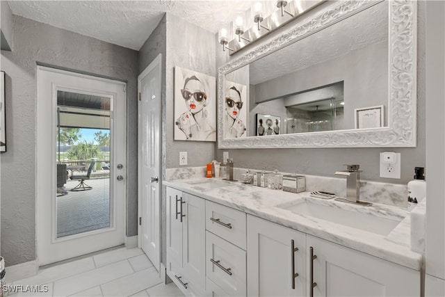 bathroom with a textured ceiling and vanity