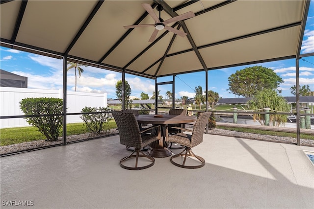 sunroom featuring ceiling fan and lofted ceiling