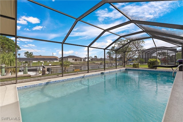 view of swimming pool featuring glass enclosure