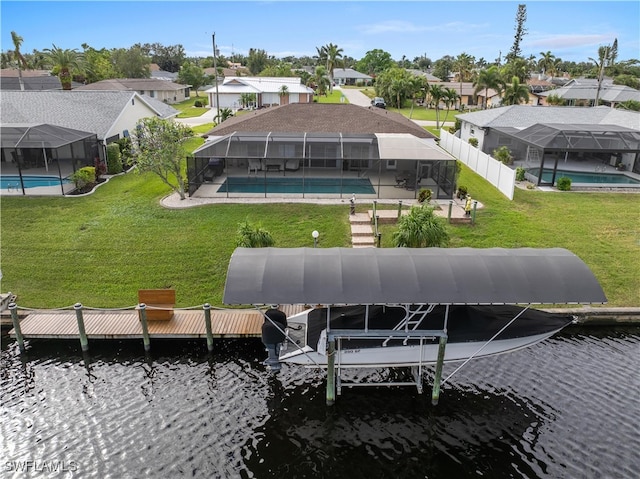 exterior space featuring a lawn, a lanai, and a water view