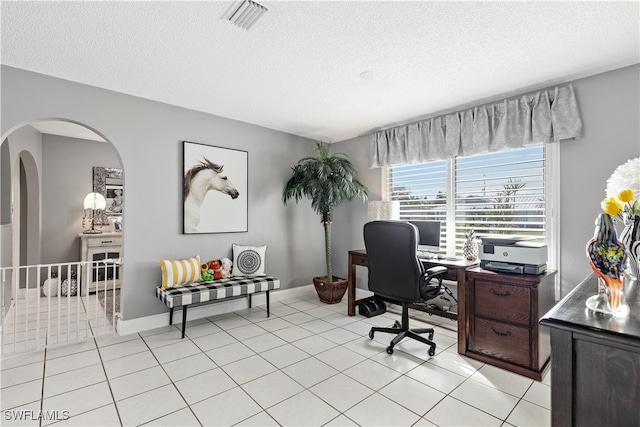 tiled home office featuring a textured ceiling