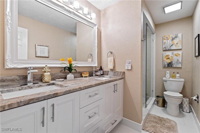 bathroom with tile patterned flooring, vanity, and toilet