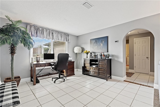 home office with light tile patterned floors and a textured ceiling