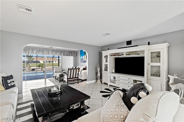 living room with light tile patterned floors and a textured ceiling