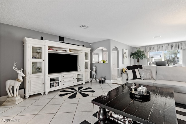 tiled living room with a textured ceiling