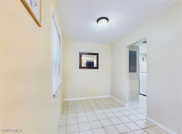 empty room featuring light tile patterned floors and electric panel