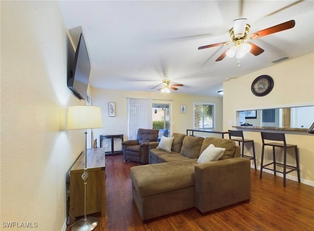 living room featuring dark hardwood / wood-style flooring and ceiling fan