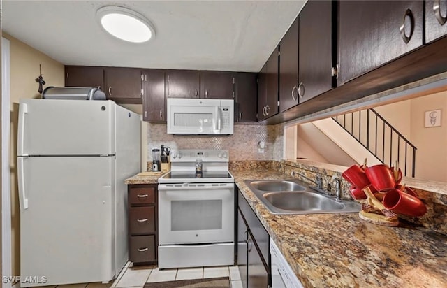 kitchen with sink, white appliances, decorative backsplash, dark brown cabinets, and light tile patterned floors